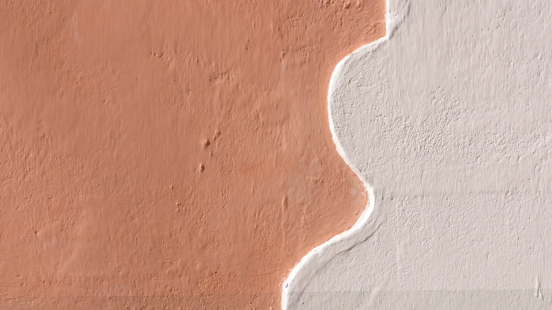 Red sand texture covered by a white clay-like wave, symbolizing website transformation